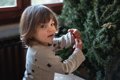 Side view of boy blowing bubbles in park