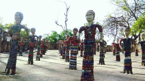 Statues in park against sky