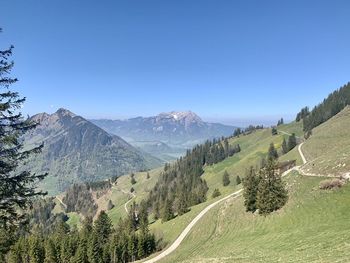 Scenic view of mountains against clear blue sky