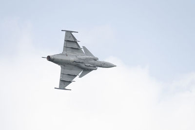 Low angle view of airplane flying against sky