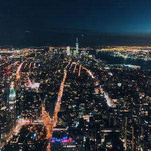 Aerial view of city lit up at night