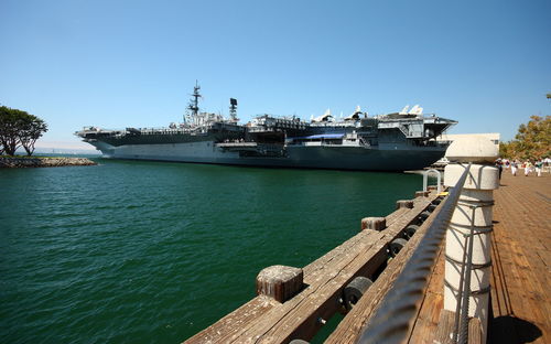 Ship moored in sea against clear sky