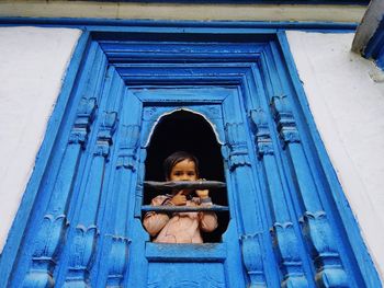 Portrait image of rural child on the blue window