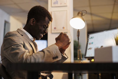 Midsection of businessman working at office