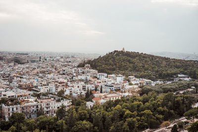 High angle view of buildings in town against sky