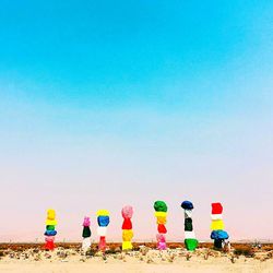 Multi colored chairs on beach against clear blue sky