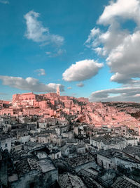 Aerial view of townscape against cloudy sky