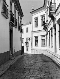 Empty alley amidst buildings in town