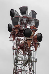 Low angle view of communications tower against sky