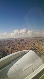 Cropped image of airplane flying over landscape