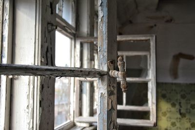 Close-up of rusty window of old building