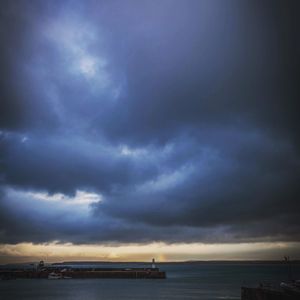 Scenic view of sea against cloudy sky