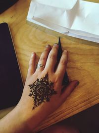 High angle view of hands on table