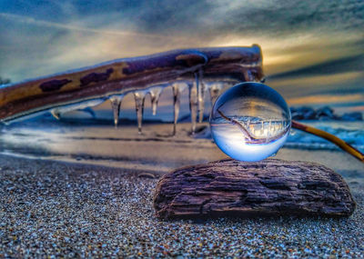 Close-up of sunglasses against sky