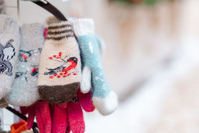 Christmas decoration at the new year's fair. winter knitted mittens for hands with bullfinches 