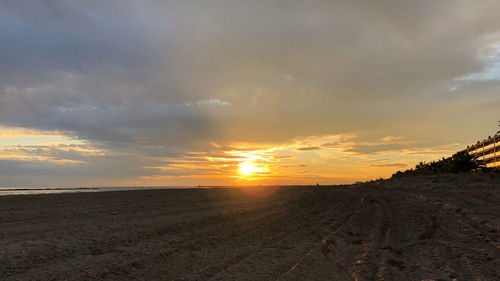 Scenic view of beach against sky during sunset