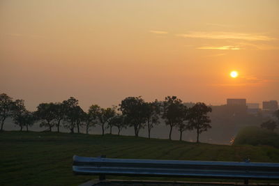 Scenic view of field against sky during sunset