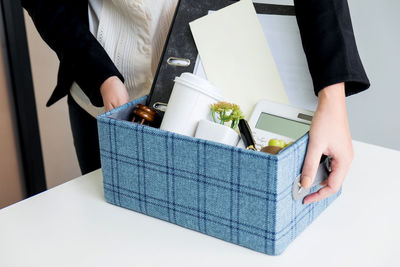 Low section of woman standing in box