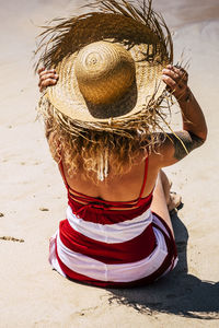 Rear view of woman standing at beach