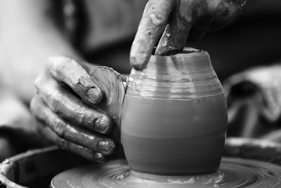 Midsection of man making pottery