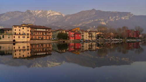 Reflection of buildings in lake against sky