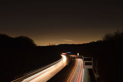 Night road with light tracks of cars