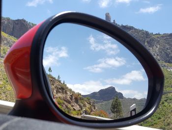 Reflection of sky on side-view mirror