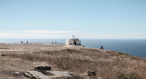 View of building by sea against sky