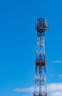 Low angle view of communications tower against blue sky. mobile or telecom 4g network.