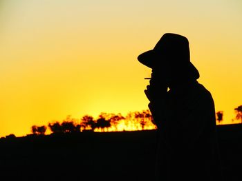 Silhouette man against sky during sunset