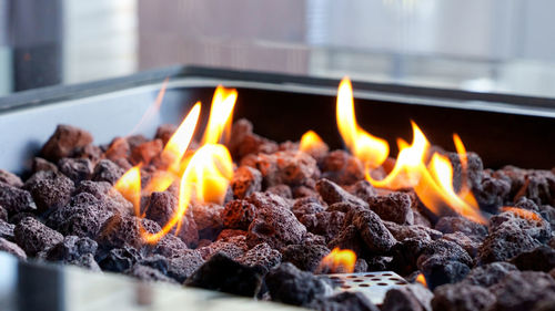 Stone firepit with fire flames in the garden