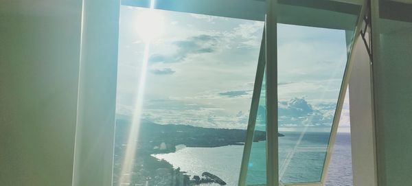 Scenic view of sea seen through glass window