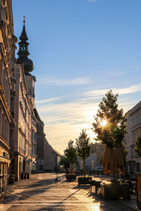 Street amidst buildings against sky in city