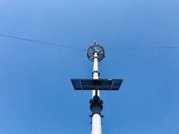 Low angle view of street light against blue sky