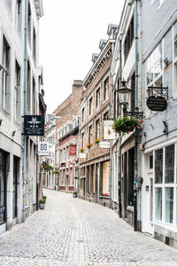 Empty alley amidst buildings in city