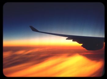 Cropped image of airplane flying over sea