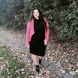 Portrait of smiling young woman standing outdoors