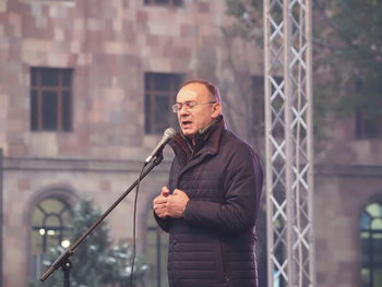 Full length of man standing in city during winter