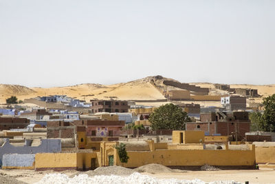 Buildings in city against clear sky