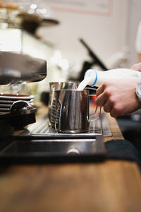 Close-up of person making coffee