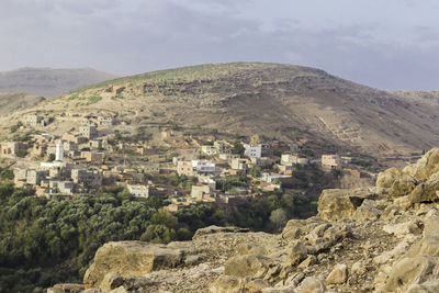 High angle view of townscape by sea against sky