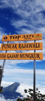 Low angle view of road sign against sky