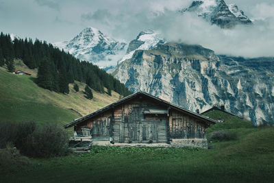 House on mountain against sky