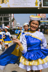 Portrait of smiling young women standing outdoors