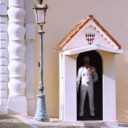 Full length of woman standing against building