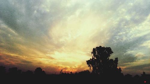 Silhouette of landscape against cloudy sky