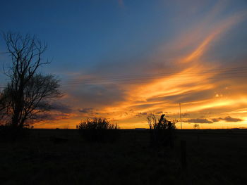 Scenic view of silhouette landscape against sky at sunset