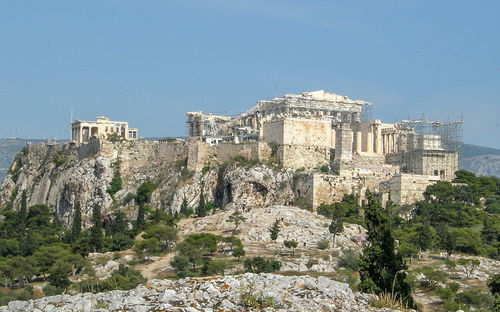 Acropolis of athens on rocky mountain against sky