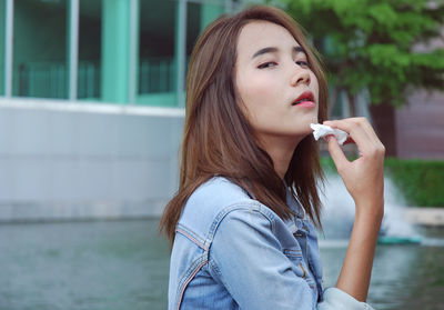 Portrait of beautiful woman holding tissue paper