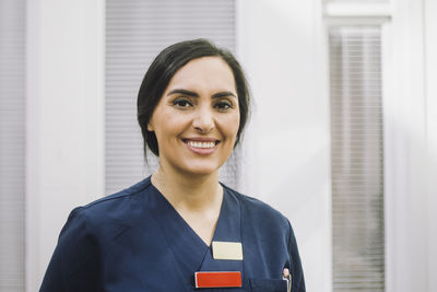 Portrait of smiling female nurse at healthcare center